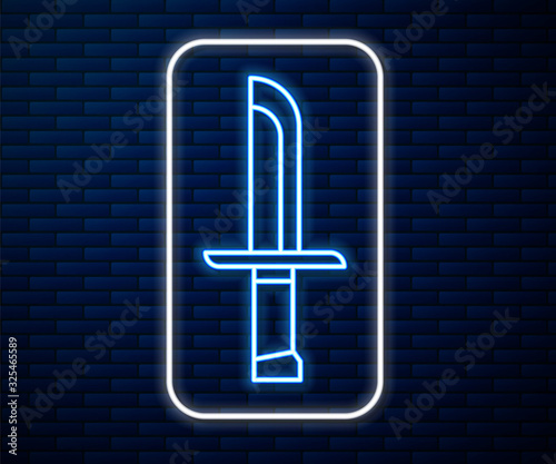 Glowing neon line Military knife icon isolated on brick wall background.  Vector Illustration