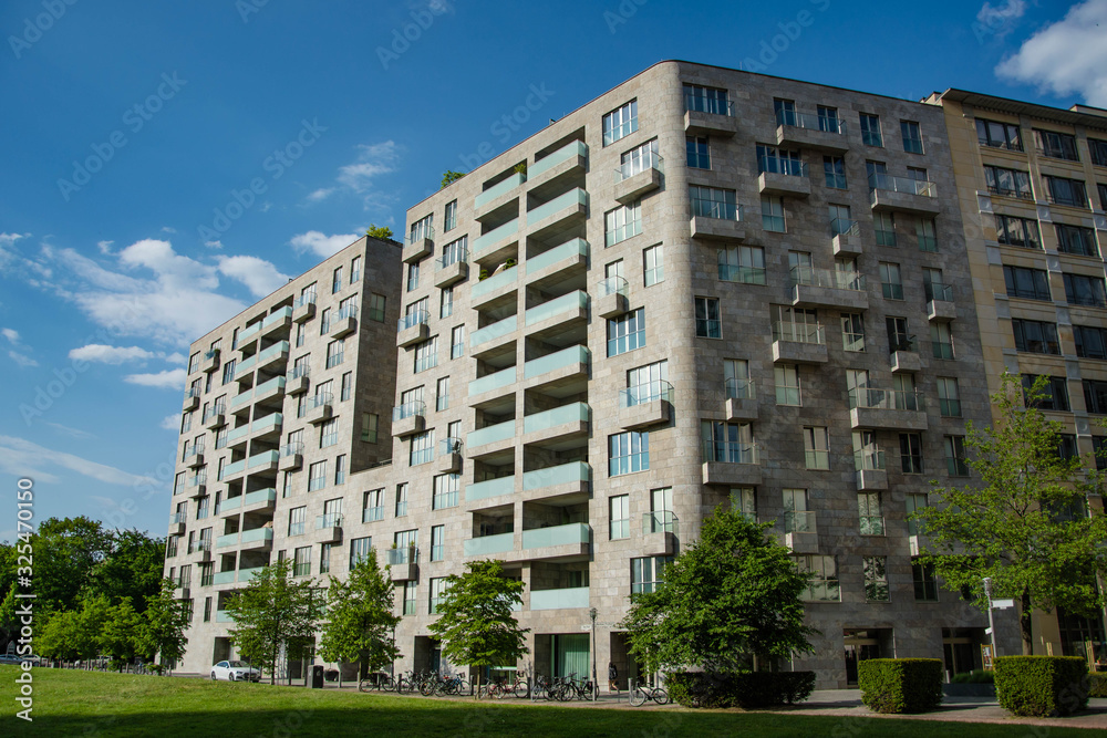 Living apartment house in Berlin, Germany. Sunny summer day. Modern architecture of residential complex.