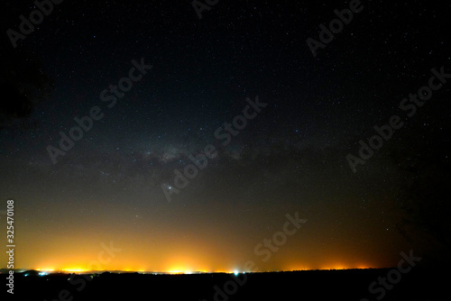Stars over Dikhololo nature reserve with ambient light on the horizon
