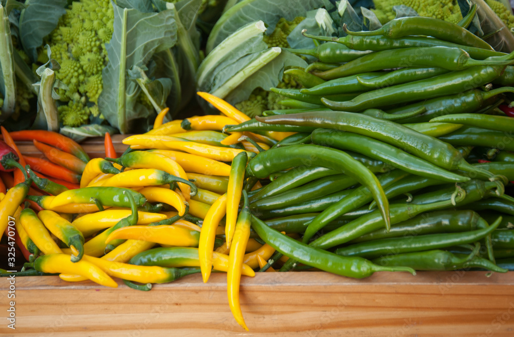background of closeup cabbage, yellow and green  hot peppers.