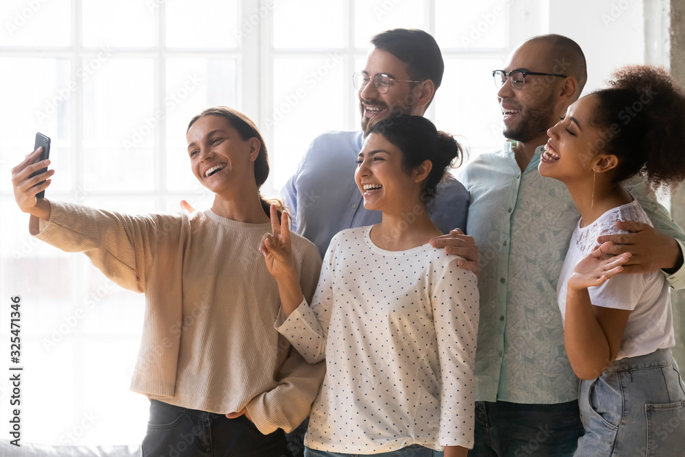 Multi-ethnic friends posing for camera making selfie photo together Multi-ethnic friends posing for camera making selfie photo together