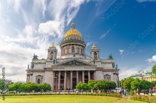 Saint Isaac's Cathedral or Isaakievskiy Sobor museum, neoclassical style building with golden dome, Russian Orthodox Church, blue sky white clouds, green lawn, Saint Petersburg Leningrad city, Russia