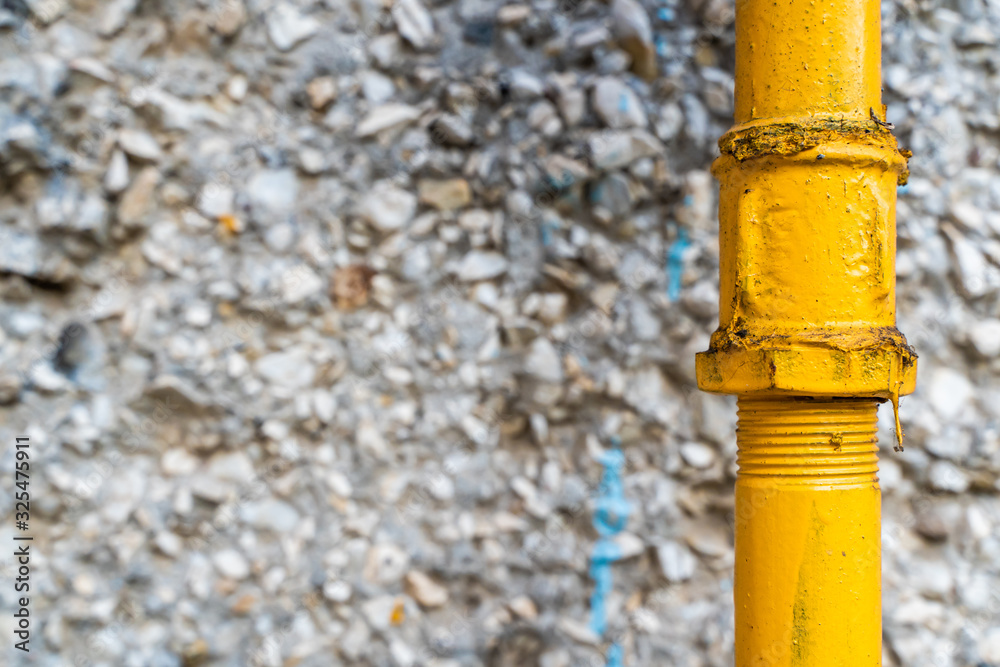 Water pipe with rubble stone wall, stock photo Water pipe with rubble stone wall, stock photo