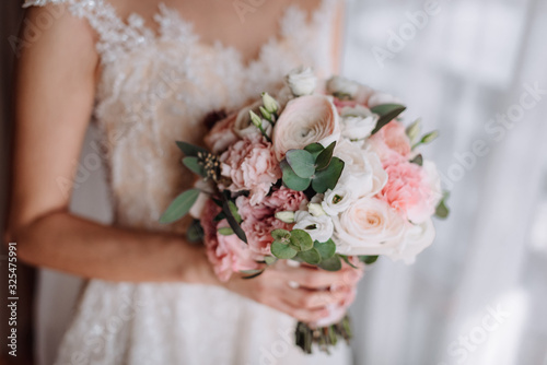 Brides wedding bouquet in women's hands. wedding flowers