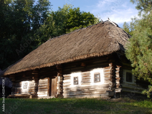 Old traditional Ukrainian village houses. Typical rural architecture. Summer outdoor landscape. Village Pirogovo.