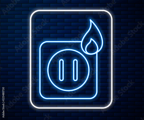 Glowing neon line Electric wiring of socket in fire icon isolated on brick wall background. Electrical safety concept. Plug outlet on fire. Vector Illustration