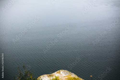 Beautiful view on lake waves. River and cliff with wildflower landscape. Bakota lake and Dnister river in Ukraine. Travelling and exploring national park. Camping on summer vacation