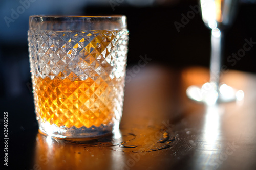 Old fashioned whiskey cocktail on wooden table 