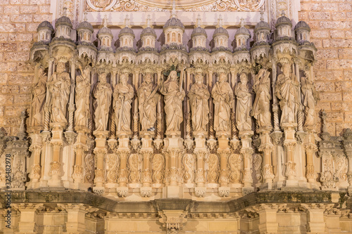 Set of statues of saints in stone from the facade of the Monastery of Montserrat, Spain