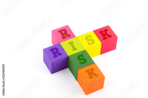 Risk concept using wooden blocks isolated on white.
