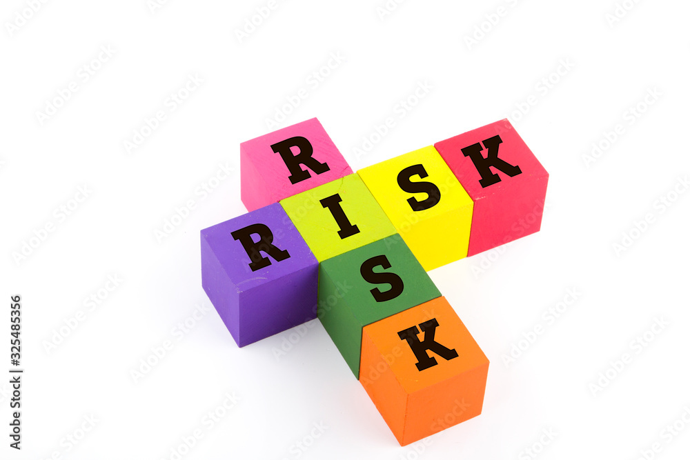 Risk concept using wooden blocks isolated on white. Risk concept using wooden blocks isolated on white.