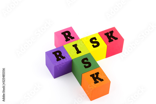 Risk concept using wooden blocks isolated on white.