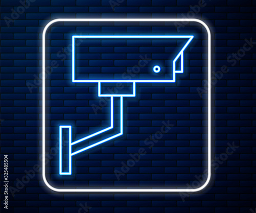 Glowing neon line Security camera icon isolated on brick wall background. Vector Illustration