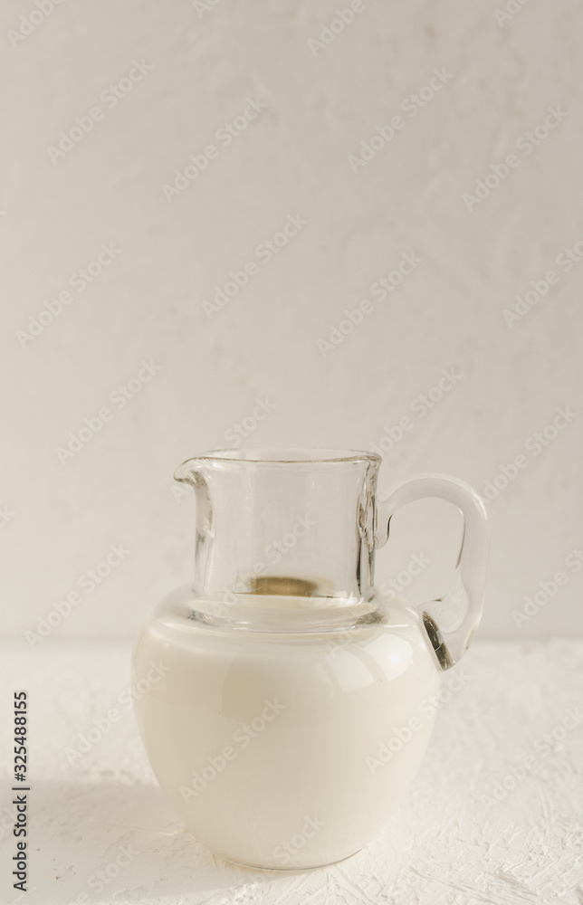 Jug of coconut milk on a white background. Vegan lifestyle. Front view. Jug of coconut milk on a white background. Vegan lifestyle. Front view.