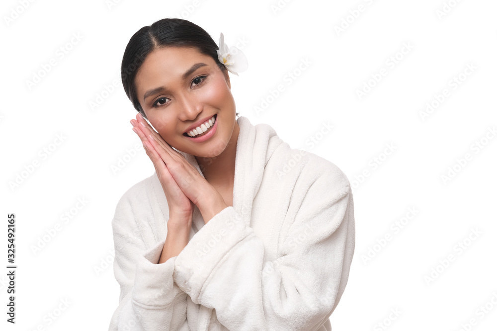 Asian model in white bath robe and orchidea flower in the hair. Asian model in white bath robe and orchidea flower in the hair.