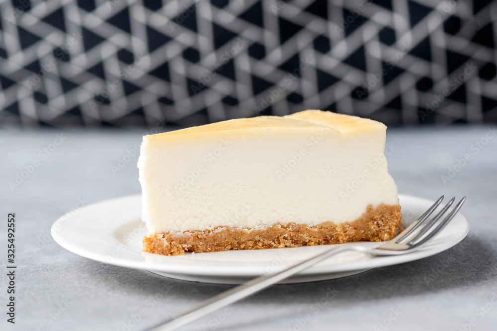 Classical cheesecake slice on white plate. Horizontal composition, copy space for design or text Classical cheesecake slice on white plate. Horizontal composition, copy space for design or text