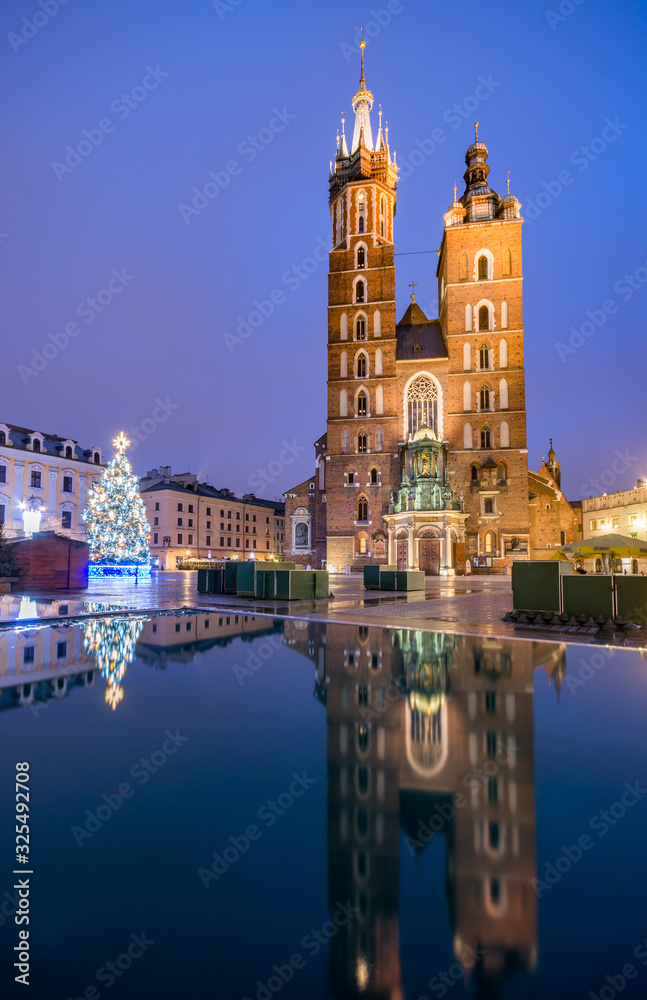 Obraz premium Krakow, Poland, St Mary's church in the morning, reflection in the water after rainy night