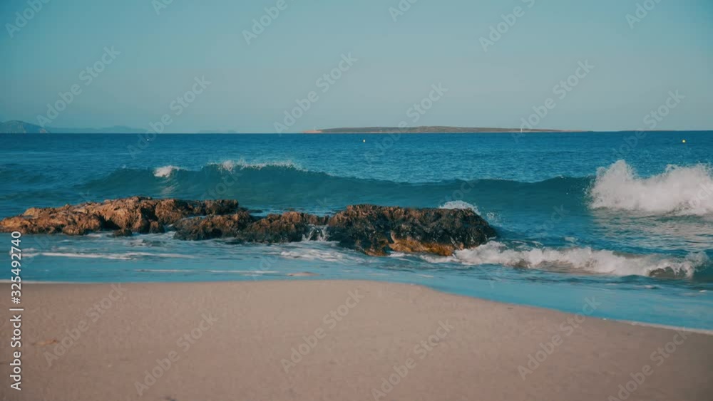 Rocky Formentera beach washed by clean sea waves Rocky Formentera beach washed by clean sea waves