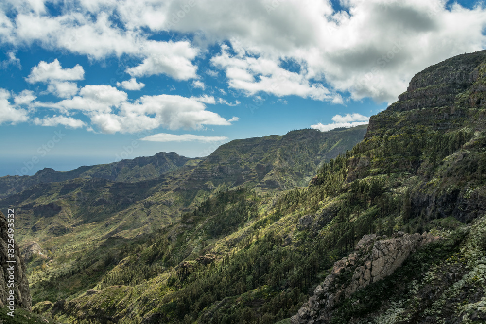 Panoramic view of Rocks - Los Roques in La Gomera island. A volcanic plug, also called a volcanic neck or lava neck, is a volcanic object created when magma hardens within a vent on an active volcano