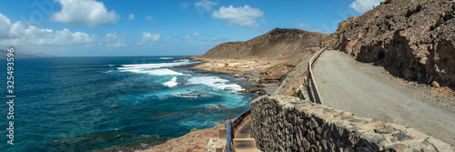 Extra large panorama from La Isleta an warm sunny day with briht blue sky and white clouds. Las Palmas, The Confital beach, Gran Canaria