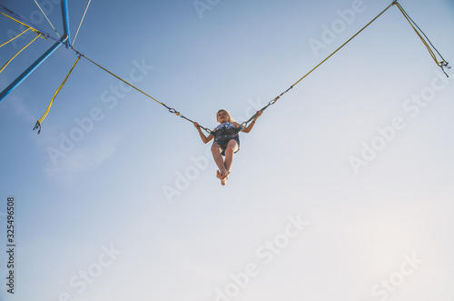 child jumping in the jumping attraction worm eye view