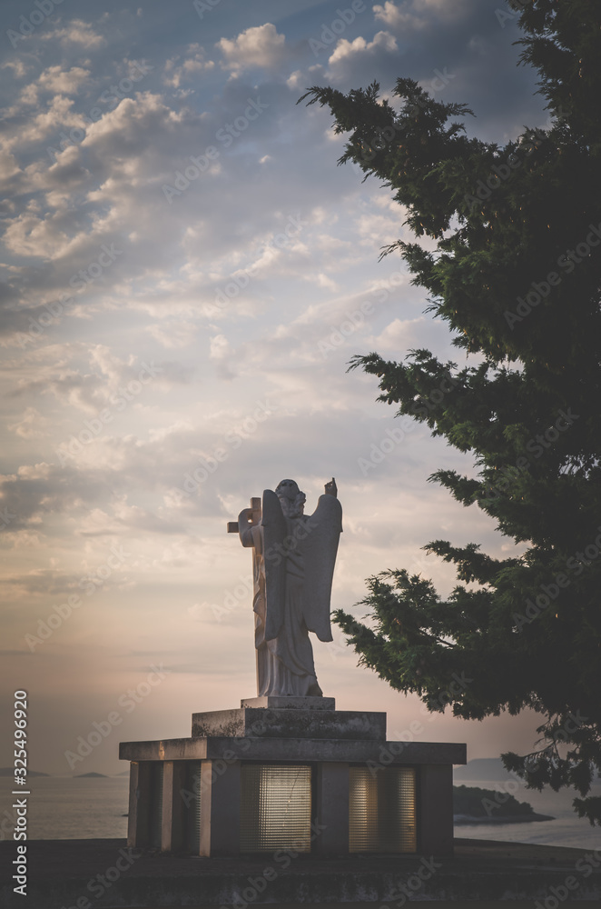 Fototapeta premium cristian saint statue at the sunset