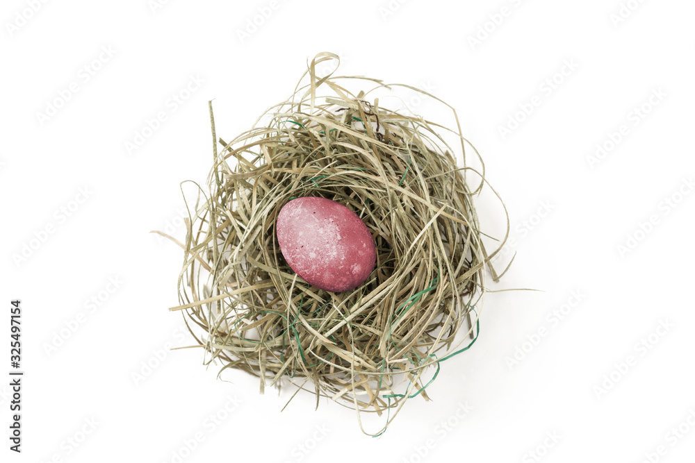 Painted easter egg in hay nest on white background Painted easter egg in hay nest on white background