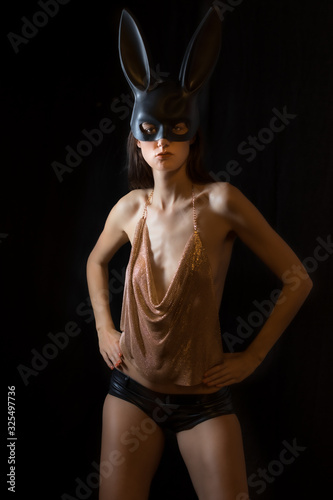 Tall young beautiful model girl with bunny mask is ready for the party