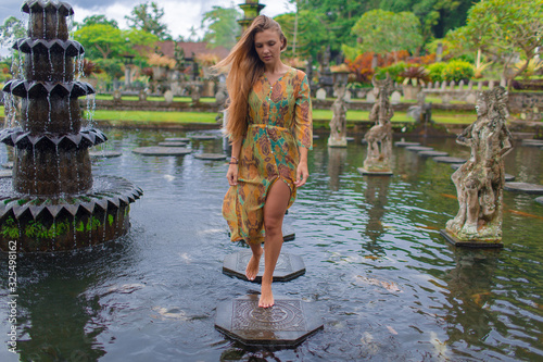 Beautiful girl in the water temple of Inlonesia. Bali. © fotoplaton