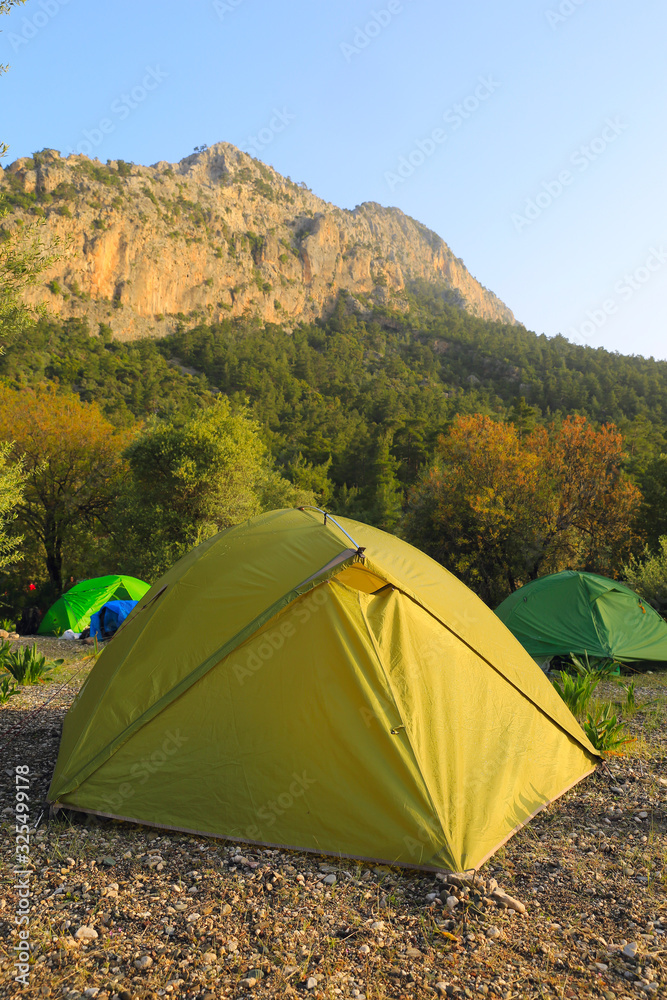 Tourist tents on camping meadow in mountains