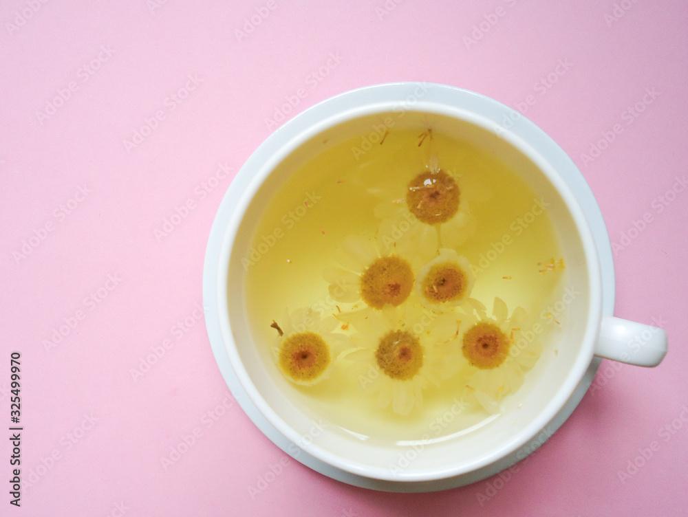 chamomile tea on the cup, top view, color background chamomile tea on the cup, top view, color background