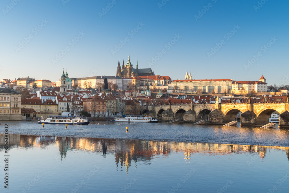 Panorama of winter Prague with reflection in the Vltava river of the Cathedral of St. Witt, Mala Strana, Charles Bridge at sunset