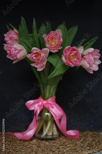 Pink Tulips in vase and ribbon dark background