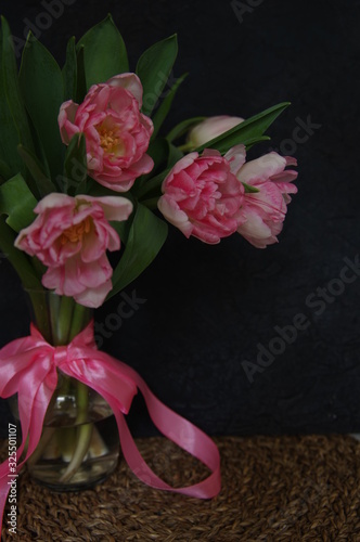 Pink Tulips in vase and ribbon dark background