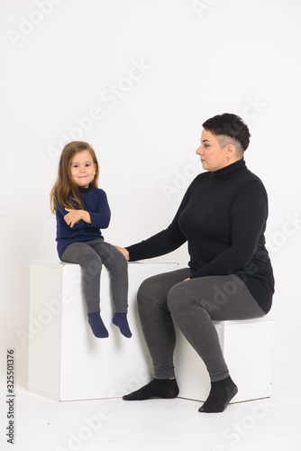 emotional portrait of mom and daughter, on a white background