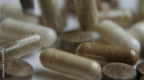 tablets and capsules of different colors and shapes fall on each other, close-up macro, 4k