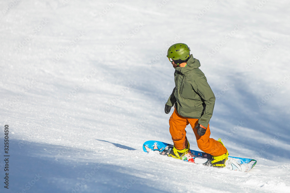 Snowboarder having fun riding hill at ski resort