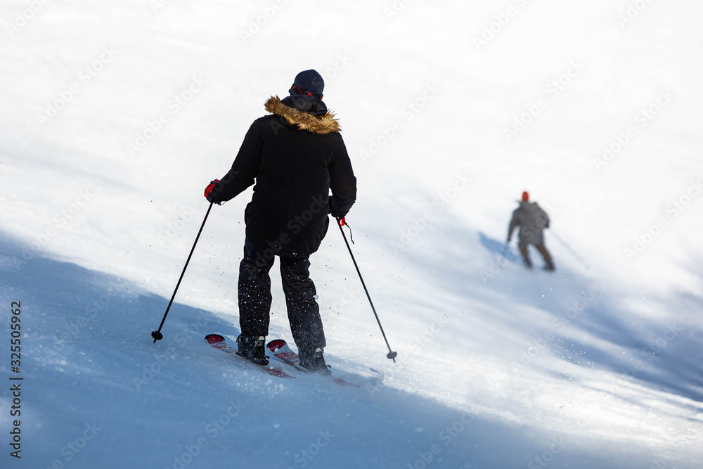 Skier jumping and having fun at resork in winter form the back Skier jumping and having fun at resork in winter form the back