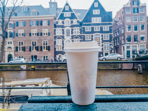 Photography White paper cup  for hot drinks on the background of Amsterdam architecture