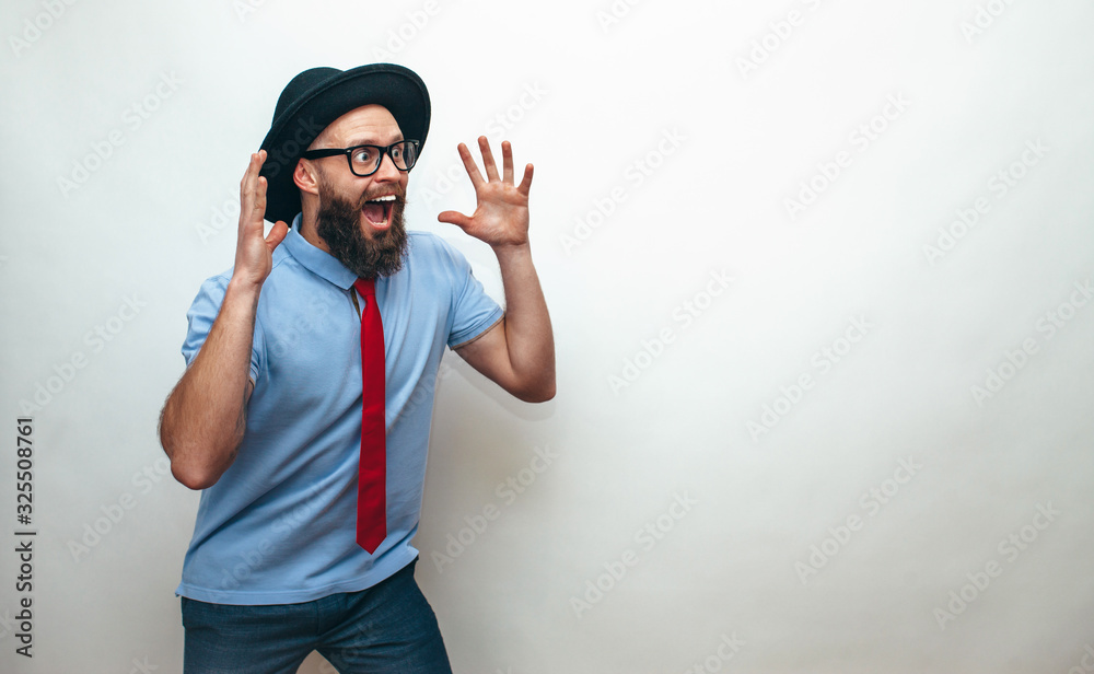 Naklejka premium Portrait of amazed hipster man with beard, wearing casual. Your text here. Wow!