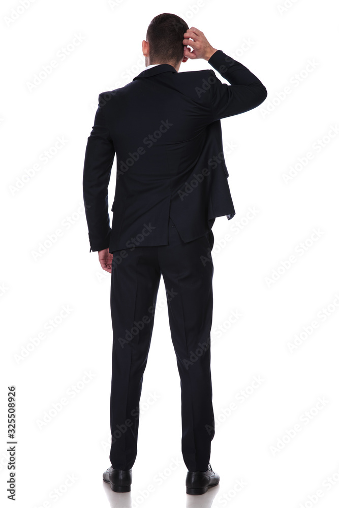 Rear view of a confused businessman scratching his head