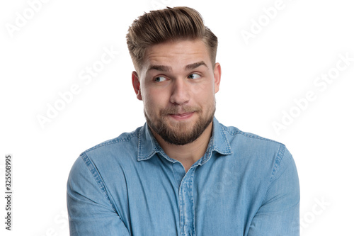 Focused casual man curiously looking away