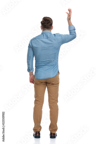 Rear view of a bothered casual man arguing and gesturing