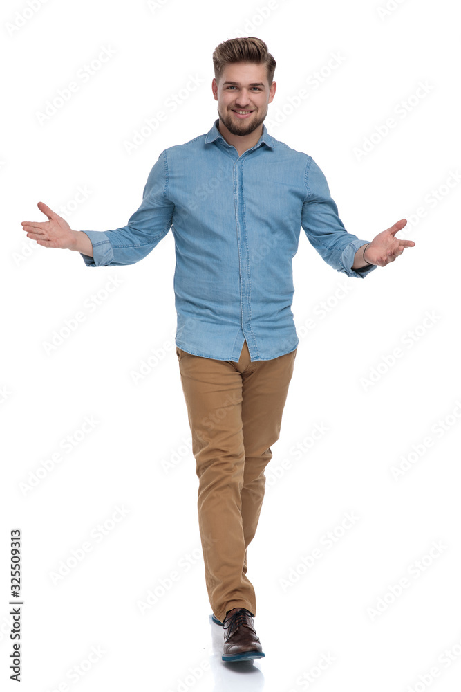 Positive casual man welcoming and smiling Positive casual man welcoming and smiling