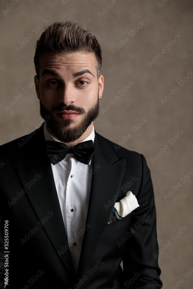 Bored groom looking forward while wearing tuxedo Bored groom looking forward while wearing tuxedo