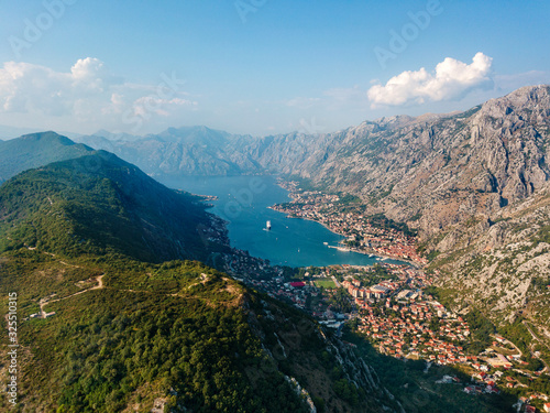 Aerial view of the Bay of Kotor  Boka. Old city of Kotor  fortifications. Mountain of St.John and the fortress. Tourism and cruise ships. The bay is the largest fjord in the Mediterranean. Montenegro