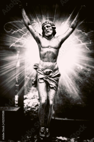 Fototapeta Naklejka Na Ścianę i Meble -  Cross with crucifixion. Backlight effect. Black and white