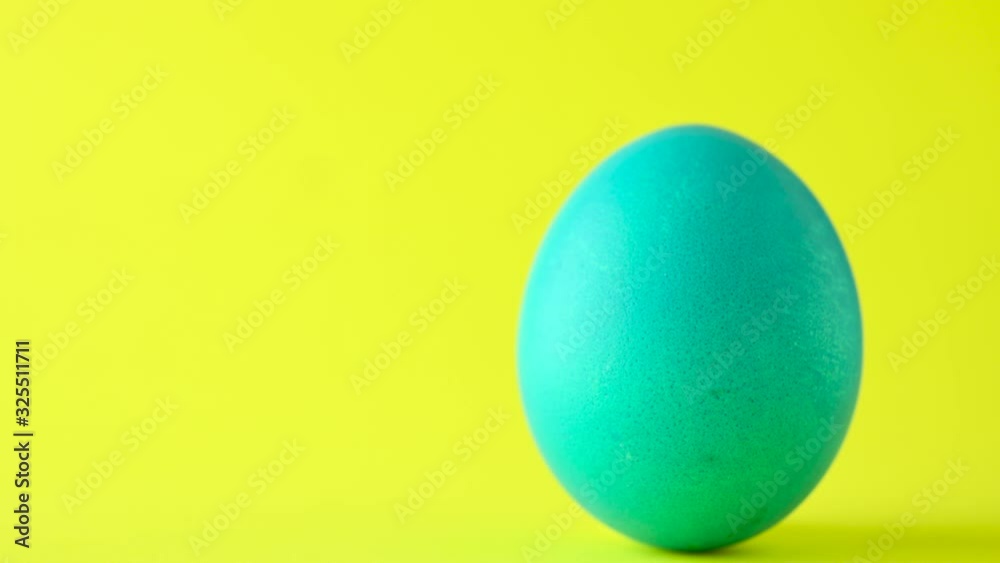 Colorful easter egg on a yellow background. Easter concept background. Colorful easter egg on a yellow background. Easter concept background.