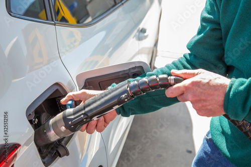Man filling up with cng (compressed natural gas) in his car.