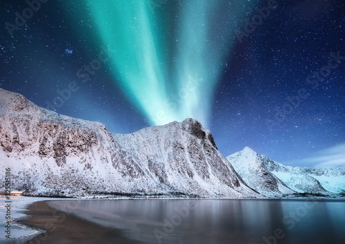 Aurora Borealis, Senja islands, Norway. Northen lights, mountains and reflection on the water. Winter landscape during polar lights. Norway travel - image
